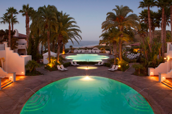 Pools and palm trees with the beach in the background